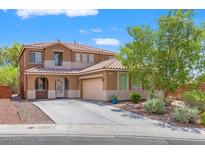 Charming two-story home with a well-maintained yard, driveway, and neutral-colored exterior at 6636 Surfbird St, North Las Vegas, NV 89084
