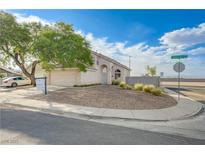 Charming single-story home featuring low maintenance desert landscaping and an attached two-car garage at 7528 Golden Yucca Dr, Las Vegas, NV 89147