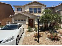 Charming two-story home with a well-manicured front yard and a cozy, inviting entrance at 8898 Promised Land Ave, Las Vegas, NV 89148