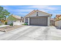 Charming single-story home features a wide driveway and a neutral color palette at 9151 Indian Breeze Dr, Las Vegas, NV 89129