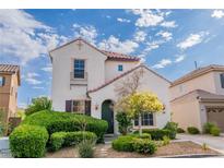 Charming two-story home featuring landscaped yard and tile roof against a beautiful sky at 10987 Santorini Dr, Las Vegas, NV 89141