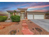 Charming home with desert landscaping, tiled roof and dramatic sunset sky at 1126 Winter Storm Dr, Henderson, NV 89052