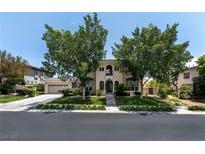Charming two-story stucco home featuring desert landscaping, arched entry, and a two-car garage at 1204 Moselle Ct, Las Vegas, NV 89144