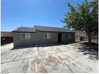 Charming single-story home with a spacious driveway and a mature tree in the front yard at 125 S 15Th St, Las Vegas, NV 89101