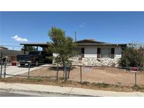 Cozy single-story home featuring a unique stone facade and fenced yard for added privacy at 2244 Pariva St, Las Vegas, NV 89115