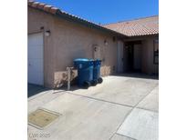 Home exterior featuring stucco siding, tile roof, and a paved driveway for convenient parking at 228 Caracas Dr, Las Vegas, NV 89145