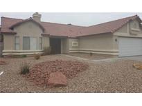 Charming single-story home with a tile roof and low-maintenance desert landscaping in the front yard at 3116 Gentle Breeze St, Las Vegas, NV 89108