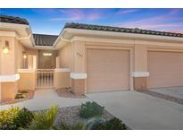 Charming single-story home featuring a well-kept yard, two-car garage, and tiled roof at 3161 Quail Song Dr # 3161, Laughlin, NV 89029