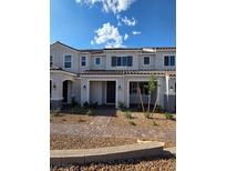 Charming two-story townhome featuring a well-manicured yard, creating a welcoming and picturesque curb appeal at 3654 Stoppani Ave, Henderson, NV 89044