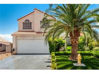 Charming two-story home featuring a well-maintained front yard and a mature palm tree at 3825 Manhattan Bridge Pl, North Las Vegas, NV 89032