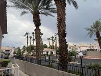 A view of the property's exterior showcasing lush palm trees and well-maintained landscaping at 4555 E Sahara Ave # 288, Las Vegas, NV 89104