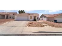 Charming single-story home featuring a two-car garage and low maintenance desert landscaping at 521 Landra Ln, Henderson, NV 89015