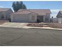 Charming single-story home with a two-car garage and low maintenance landscaping in the front yard at 521 Landra Ln, Henderson, NV 89015