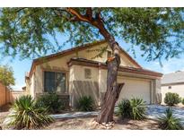 Charming one-story home featuring desert landscaping, an attached two-car garage, and stucco walls at 5605 Midnight Breeze St, North Las Vegas, NV 89081