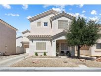 Charming two-story home with neutral stucco, manicured landscaping, and covered front porch at 5967 Aimless St, Henderson, NV 89011