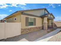 Tan single story home with stone accents, low maintenance yard, and desert landscaping at 794 Sunny Sagebrush St, Henderson, NV 89011