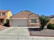 Charming single-story home featuring a two-car garage, desert landscaping, and a classic tile roof at 8900 Big Bear Pines Ave, Las Vegas, NV 89143
