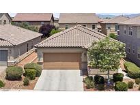 Charming single-story home featuring a two-car garage, desert landscaping and a tile roof at 9288 Valley Betica Ave, Las Vegas, NV 89148