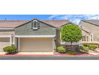 Charming townhouse featuring a two-car garage and well-maintained landscaping at 979 Coatbridge St, Las Vegas, NV 89145