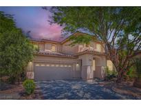 Charming two-story home features a tile roof, stucco siding, and mature landscaping in a suburban neighborhood at 11074 Caramel Crest Ct, Las Vegas, NV 89135