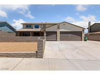 Charming two-story home with a well-manicured lawn and a spacious three car driveway at 1511 Irene Dr, Boulder City, NV 89005