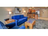 Comfortable living room featuring a blue sofa, contemporary art, and stylish, modern decor at 211 E Flamingo Rd # 615, Las Vegas, NV 89169