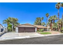 Inviting single-story home featuring a well-maintained front yard, mature trees, and a spacious two-car garage at 2504 La Solana Way, Las Vegas, NV 89102