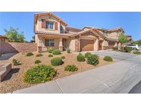 Inviting two-story home featuring desert landscaping, a two-car garage, and a charming stucco facade at 261 Via Morelli, Henderson, NV 89011