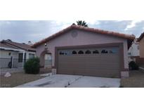 Single-Gathering home with a two-car garage with decorative windows and a terracotta tile roof at 2777 Beaconfalls Way, Las Vegas, NV 89142