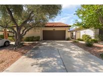 Charming home featuring a spacious driveway and a two-car garage with a well-maintained front yard at 2857 San Lago Ct, Las Vegas, NV 89121