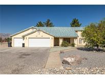 Charming single-story home with a three-car garage and low maintenance desert landscaping at 3580 S Shawnee Ave, Pahrump, NV 89048