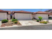 Charming townhome featuring a tile roof, two-car garage, and low-maintenance landscaping in a desirable community at 445 Intrepid Ct, Boulder City, NV 89005