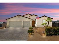 Charming single-story home featuring a tile roof, two-car garage, and well-manicured front yard at 4620 E Suntree Ct, Pahrump, NV 89061