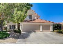 Charming home featuring a symmetrical design, a three-car garage, and a terracotta-tiled roof at 5908 Marbrisas Ln, Las Vegas, NV 89130