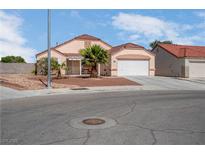 Charming single-story home with a tile roof, two-car garage, desert landscaping, and covered front porch at 6138 Crystal Flower Way, North Las Vegas, NV 89031