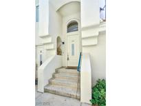Inviting entrance with a white door and steps leading up to the home at 7648 Rolling View Dr # 201, Las Vegas, NV 89149