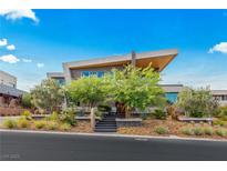 Stunning modern home with unique roofline, professional landscaping, and striking architectural design at 8 Meadowhawk Ln, Las Vegas, NV 89135