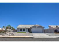 Charming single-story home with a well-manicured front yard and attached two-car garage at 842 Envoy Cir, Henderson, NV 89002