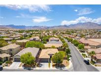 Stunning aerial view of a desert community nestled beneath majestic mountains and clear skies at 913 Hickory Park St, Las Vegas, NV 89138