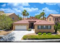 Charming single-story home with a well-manicured lawn, a two-car garage, and a beautiful tile roof at , Las Vegas, NV 89113