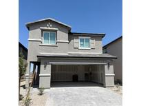 Charming two-story home with a two-car garage and stone accents against a bright blue sky at 10406 Luna Mezza Ave # Lot 192, Las Vegas, NV 89141