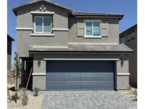 Charming two-story home featuring a gray stucco facade, and a two-car garage, offering a cozy, modern living space at 10406 Luna Mezza Ave # Lot 192, Las Vegas, NV 89141