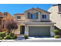 Charming two-story home features a tile roof, neutral stucco, shutters, and a two-car garage at 10717 Red Badge Ave, Las Vegas, NV 89166