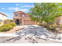 Charming two-story home featuring a well-maintained front yard and a spacious two-car garage at 11749 Villa San Michele Ct, Las Vegas, NV 89138
