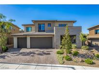 Modern two-story home featuring a three-car garage and well-maintained front yard landscaping at 12332 Switchgrass Ave, Las Vegas, NV 89138