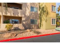 Charming exterior of a multi-story building with private balconies and well-maintained landscaping at 1812 N Decatur Blvd # 103, Las Vegas, NV 89108