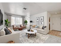 Bright living room features contemporary decor, plush seating, and large windows for natural light at 1846 N Decatur Blvd # 104, Las Vegas, NV 89108