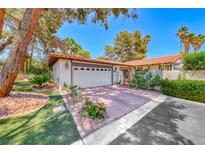 Charming single story home featuring a brick driveway, two car garage and desert landscaping at 2101 Plaza Del Fuentes, Las Vegas, NV 89102