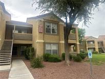 A two-story condo building featuring stairs and balconies at 2300 E Silverado Ranch Blvd # 1104, Las Vegas, NV 89183