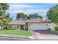 Charming single-story home with a tile roof, well-manicured lawn, and a two-car garage at 3220 Calle De El Cortez, Las Vegas, NV 89102